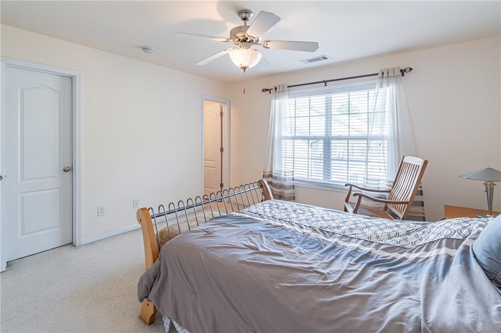 2182 Hyssop Way Buford, GA 30519 - Photo 13 of 16 a bedroom with a bed and a window