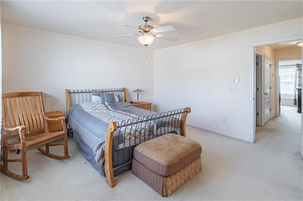 2182 Hyssop Way Buford, GA 30519 - Photo 14 of 16 a bedroom with furniture and a chandelier