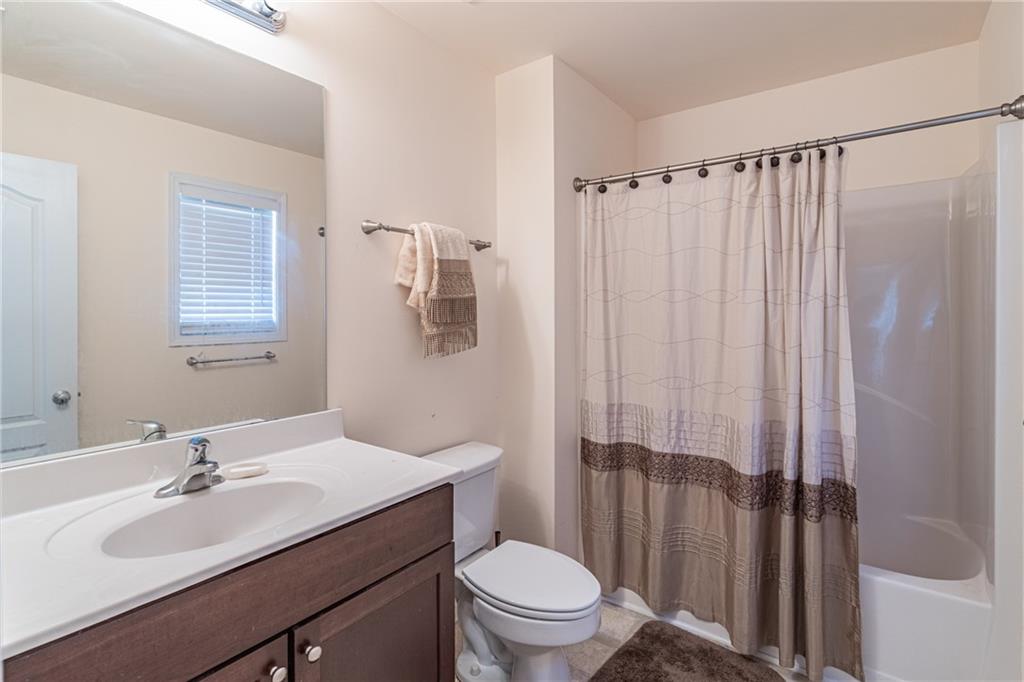 2182 Hyssop Way Buford, GA 30519 - Photo 15 of 16 a bathroom with a sink toilet a mirror and shower curtain