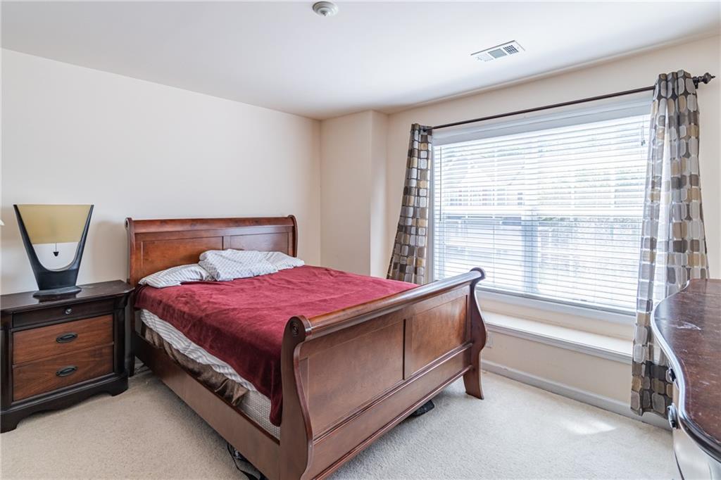 2182 Hyssop Way Buford, GA 30519 - Photo 16 of 16 a spacious bedroom with a bed and window