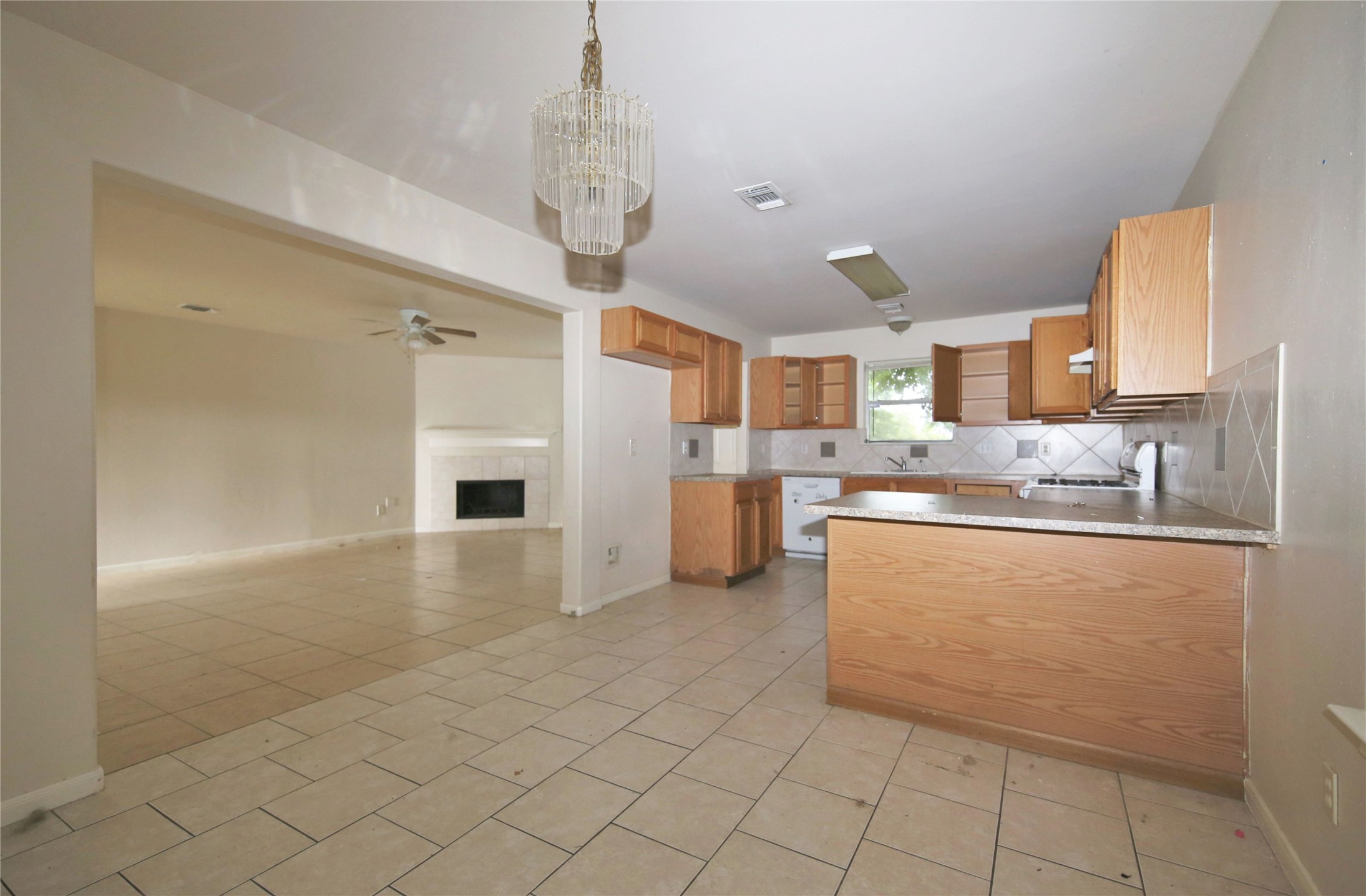 6923 Cheshire Park Road Houston, TX 77088 - Photo 4 of 9 a kitchen with stainless steel appliances granite countertop a refrigerator and a stove top oven