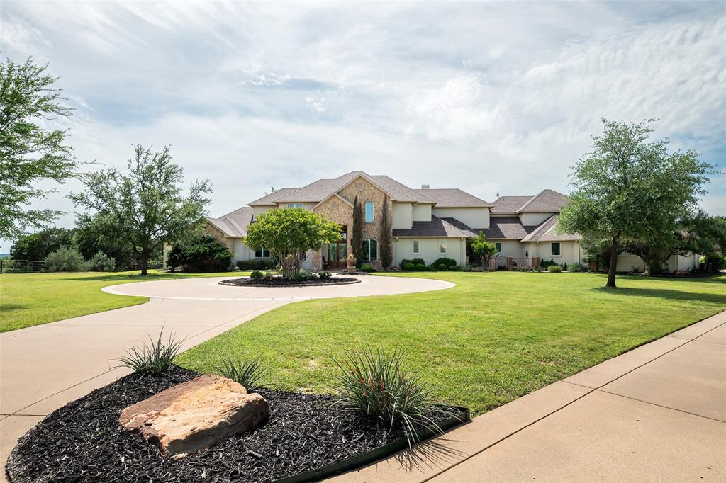 2312 Cactus Rio Lane Weatherford, TX 76087 - Photo 3 of 37 a view of a street with a houses in the background
