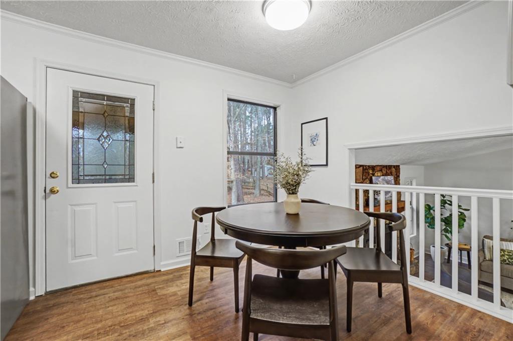 520 Victoria Road Woodstock, GA 30189 - Photo 13 of 42 a view of a dining room with furniture and wooden floor