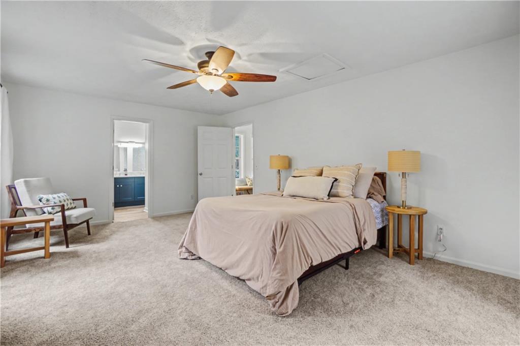 520 Victoria Road Woodstock, GA 30189 - Photo 17 of 42 a bedroom with a bed and a chandelier