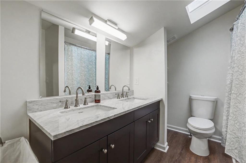 520 Victoria Road Woodstock, GA 30189 - Photo 18 of 42 a bathroom with a granite countertop sink a toilet and a mirror