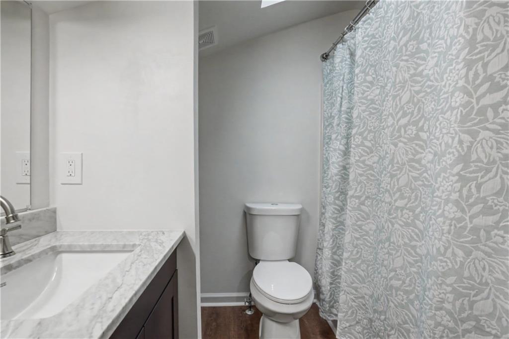 520 Victoria Road Woodstock, GA 30189 - Photo 19 of 42 a bathroom with a granite countertop toilet and a sink