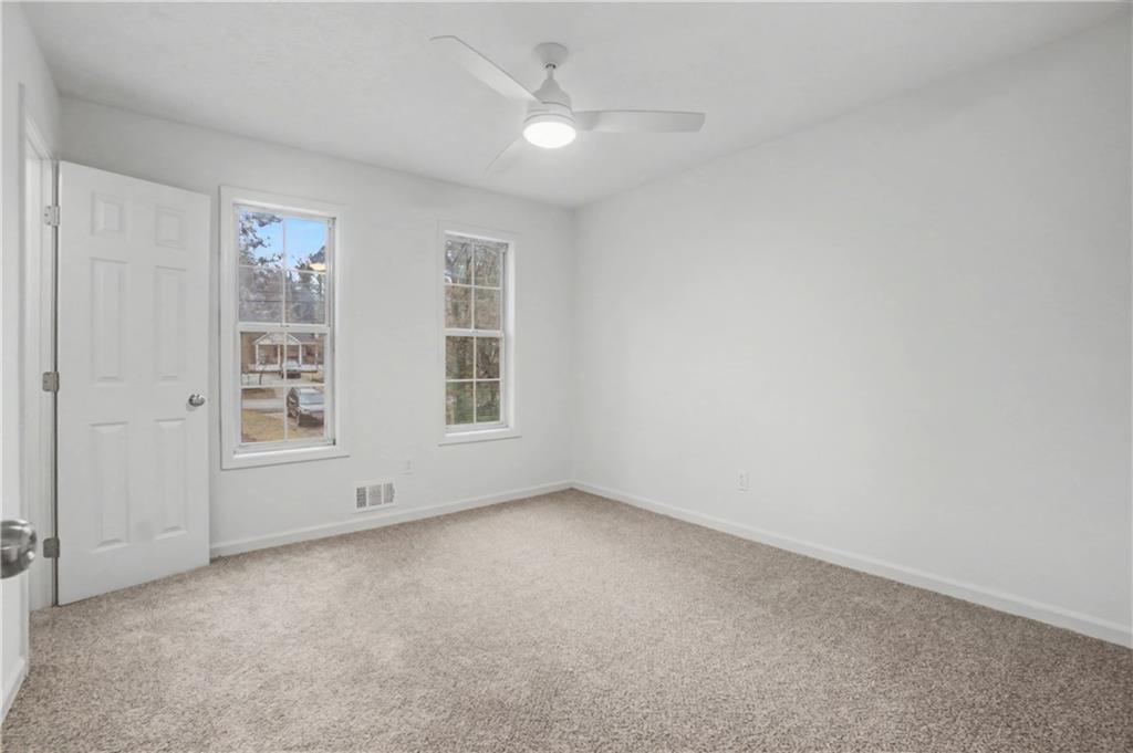 520 Victoria Road Woodstock, GA 30189 - Photo 22 of 42 an empty room with windows and ceiling fan
