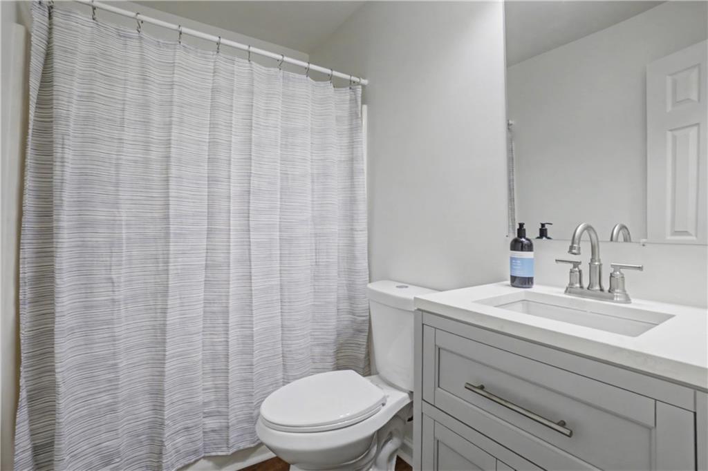 520 Victoria Road Woodstock, GA 30189 - Photo 23 of 42 a bathroom with a sink a toilet and shower curtain