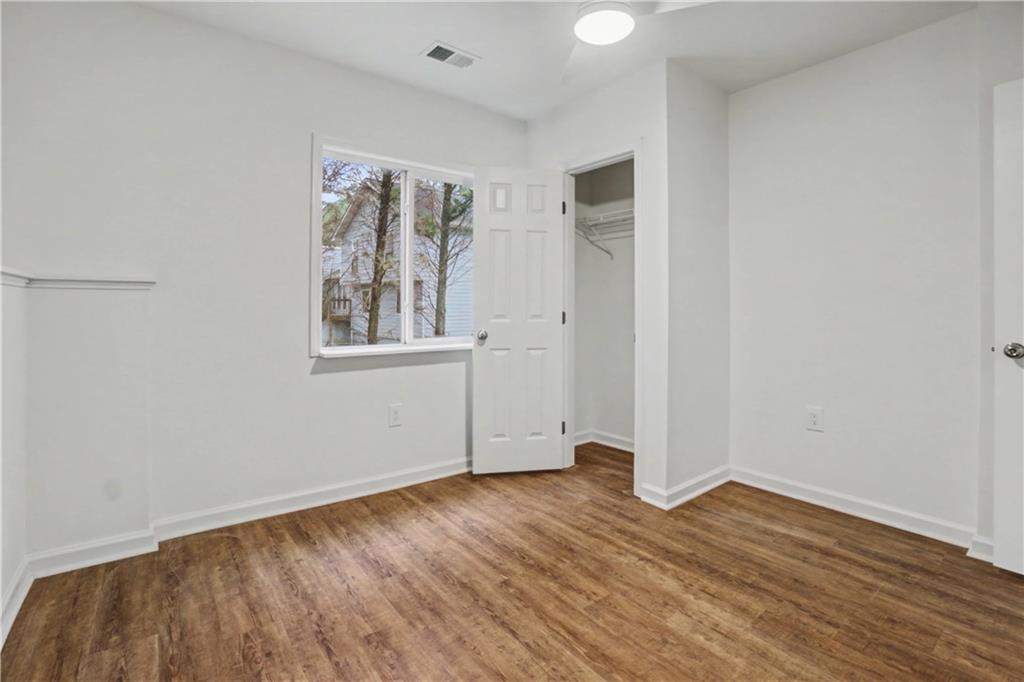 520 Victoria Road Woodstock, GA 30189 - Photo 28 of 42 an empty room with wooden floor and windows