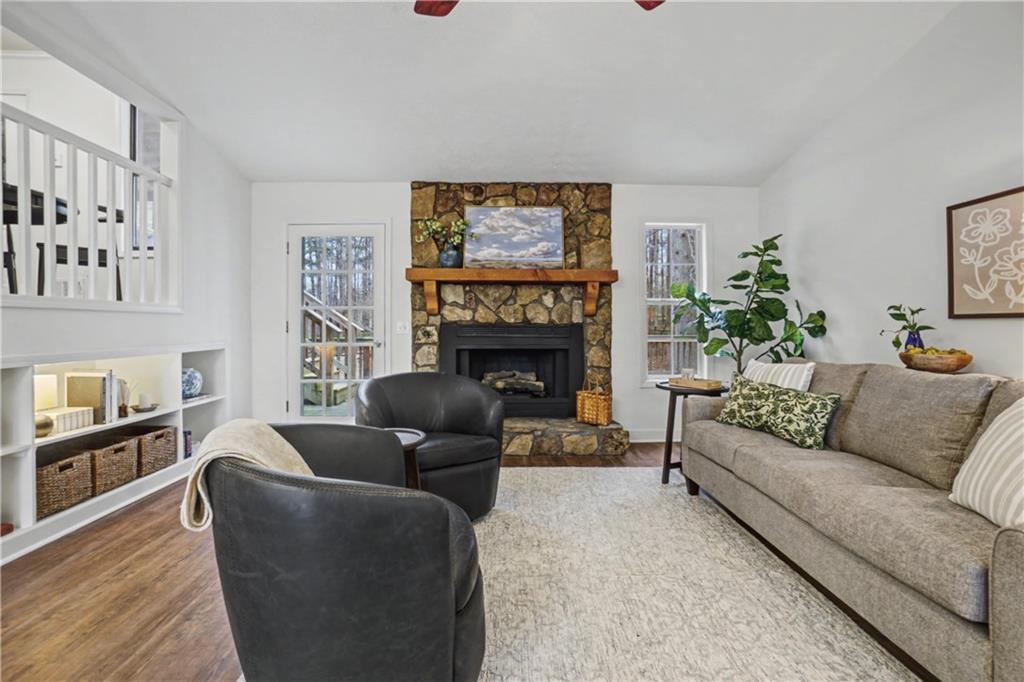 520 Victoria Road Woodstock, GA 30189 - Photo 7 of 42 a living room with furniture a fireplace and a flat screen tv