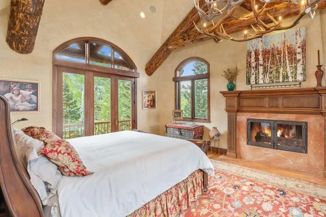 a bedroom with a bed and a fireplace