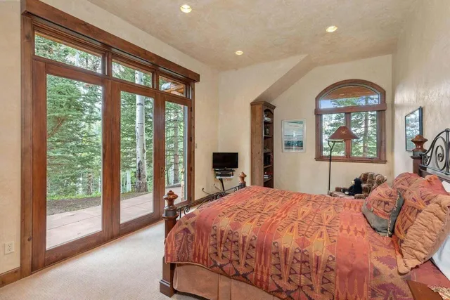 a bedroom with a large bed and a large window