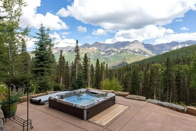 a view of a sitting area with trees in the background