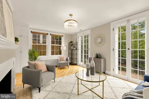 a kitchen with stainless steel appliances a stove a chandelier a sink and cabinets