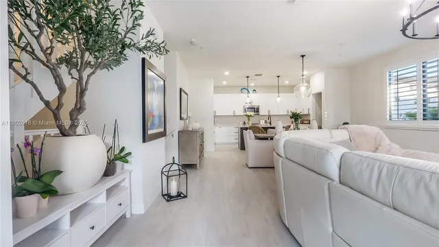 a kitchen with a sink a counter space appliances and cabinets