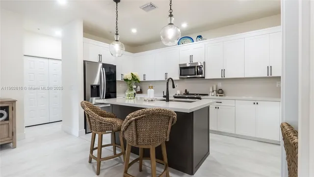 a kitchen with stainless steel appliances granite countertop a sink stove and cabinets