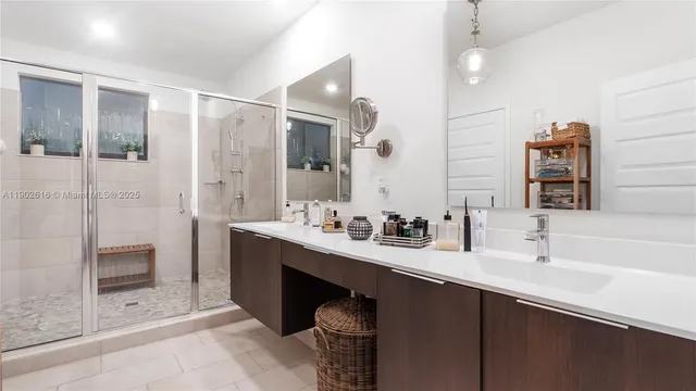 a view of a porch with a floor to ceiling window and potted plants