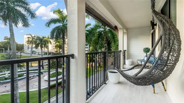 a view of a balcony with potted plants