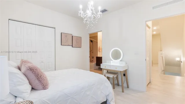 a bedroom with a bed and a painting on the wall