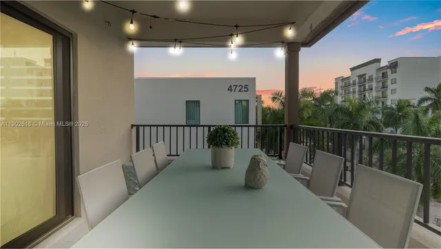 a living room with furniture a chandelier and a flat screen tv