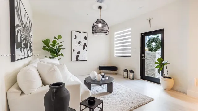 a living room with furniture and a chandelier