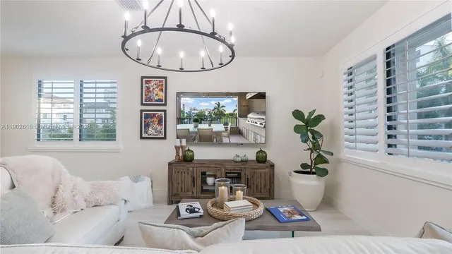 a living room with furniture and a kitchen area