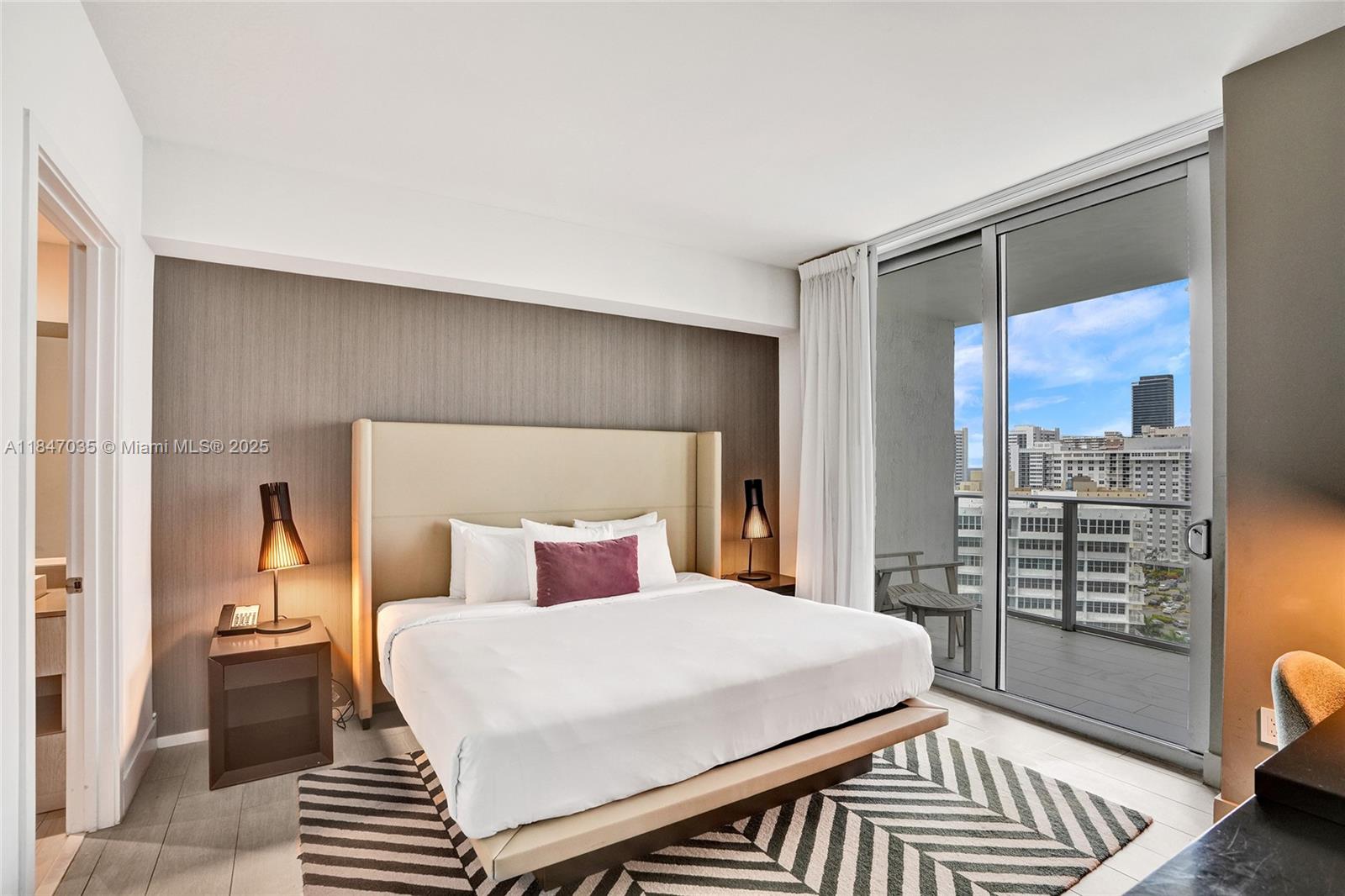 4010 South Ocean Drive, Unit R908 Hollywood, FL 33019 - Photo 13 of 53 a bedroom with a bed and wooden floor