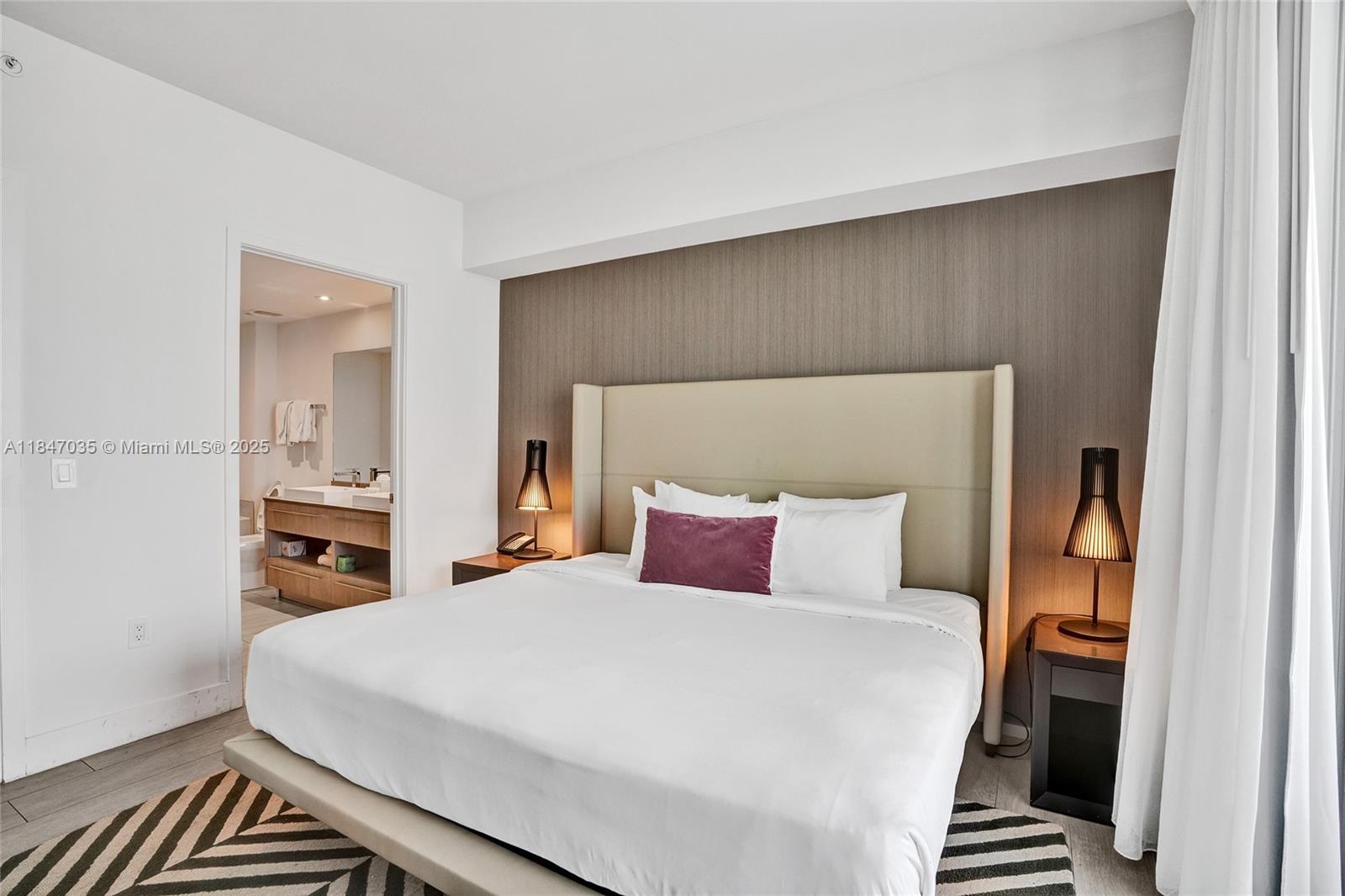 4010 South Ocean Drive, Unit R908 Hollywood, FL 33019 - Photo 14 of 53 a bedroom with a large bed and a chandelier