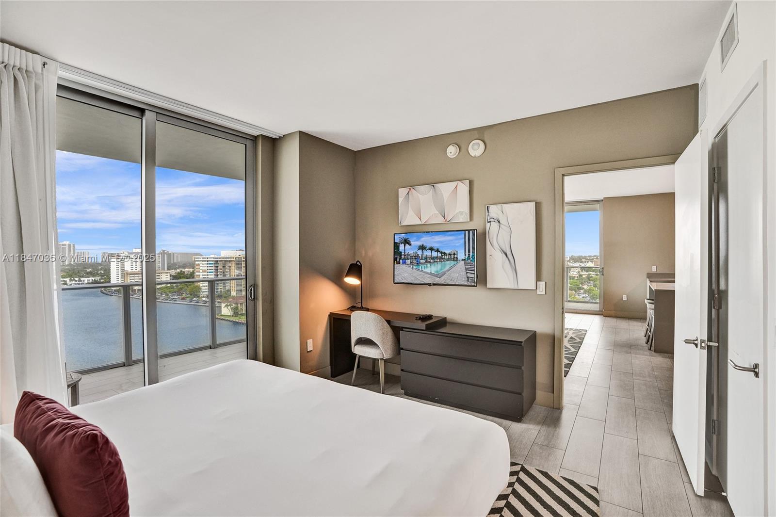 4010 South Ocean Drive, Unit R908 Hollywood, FL 33019 - Photo 15 of 53 a bedroom with a bed and a dresser