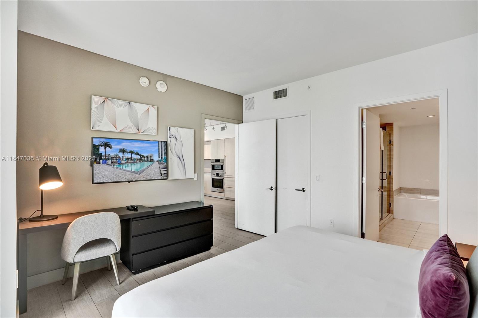 4010 South Ocean Drive, Unit R908 Hollywood, FL 33019 - Photo 16 of 53 a bedroom with a bed and a chair