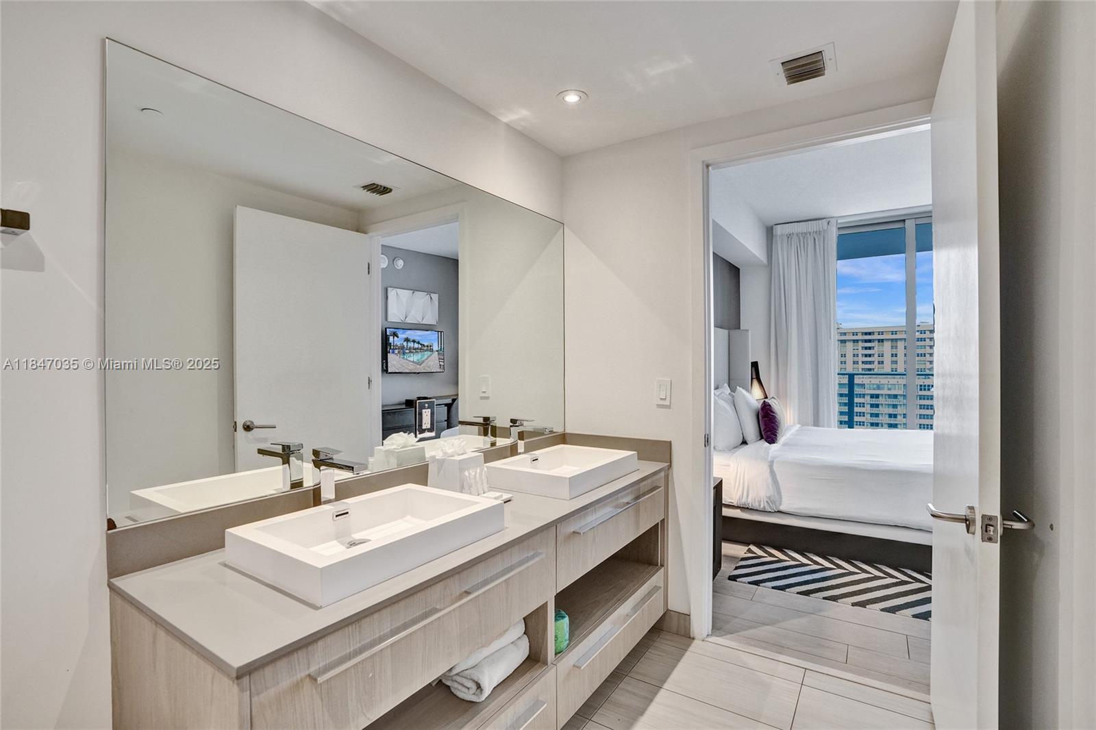 4010 South Ocean Drive, Unit R908 Hollywood, FL 33019 - Photo 20 of 53 a en suite bathroom with a sink double vanity and a mirror