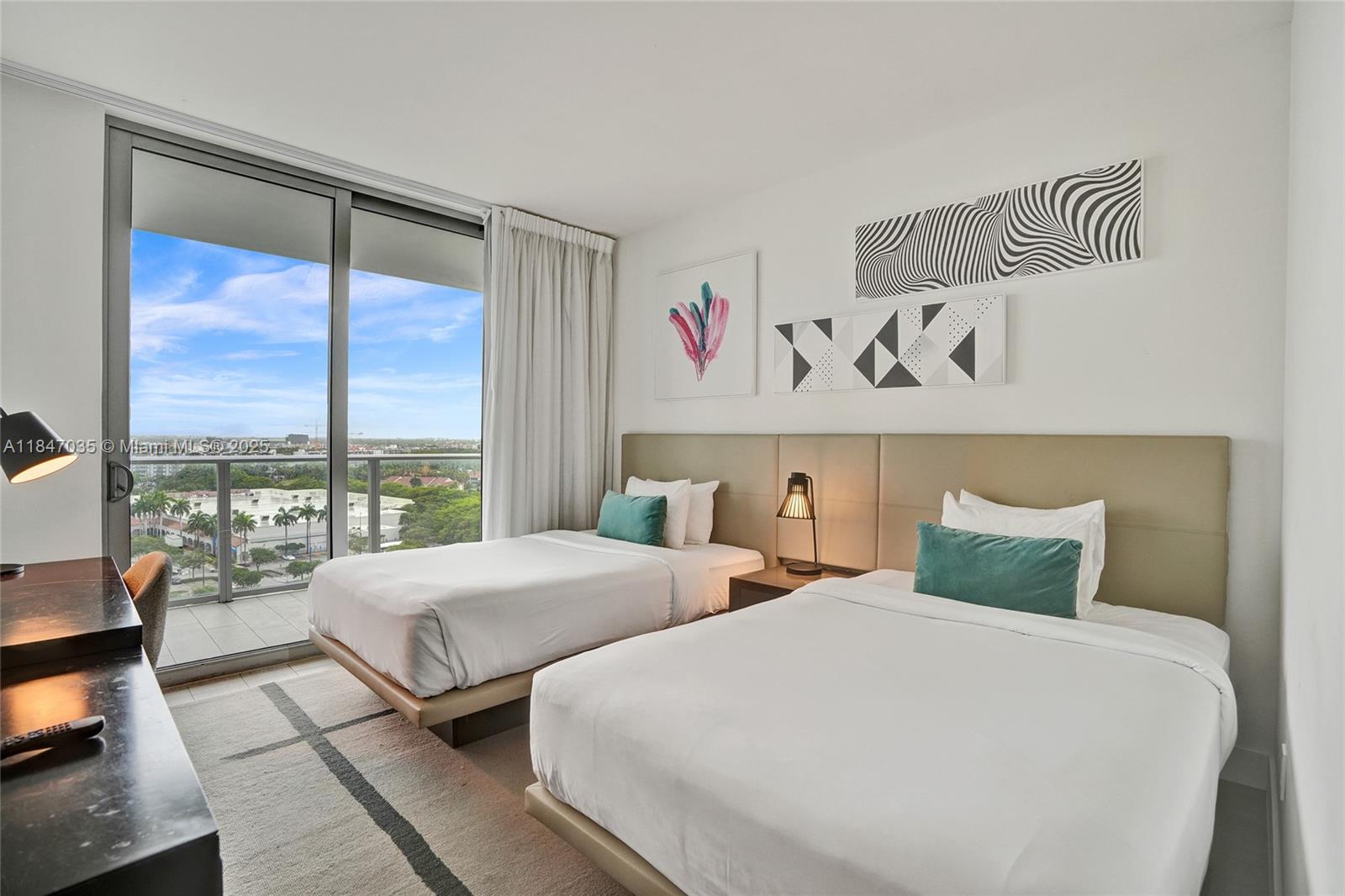 4010 South Ocean Drive, Unit R908 Hollywood, FL 33019 - Photo 30 of 53 a bedroom with two beds and a large window