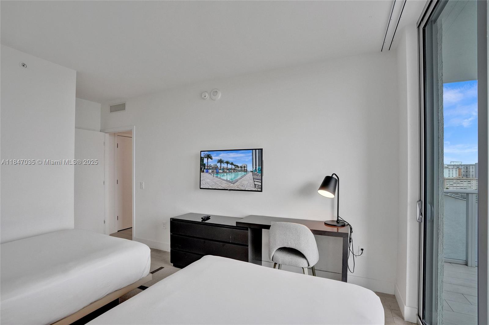 4010 South Ocean Drive, Unit R908 Hollywood, FL 33019 - Photo 32 of 53 a bedroom with a bed and a table in it