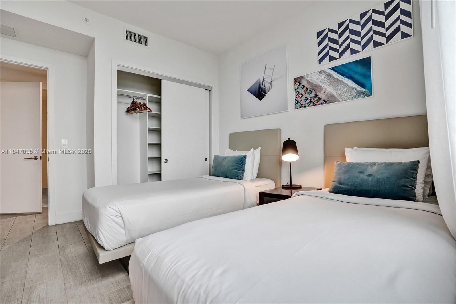 4010 South Ocean Drive, Unit R908 Hollywood, FL 33019 - Photo 38 of 53 a bedroom with a bed and a chandelier