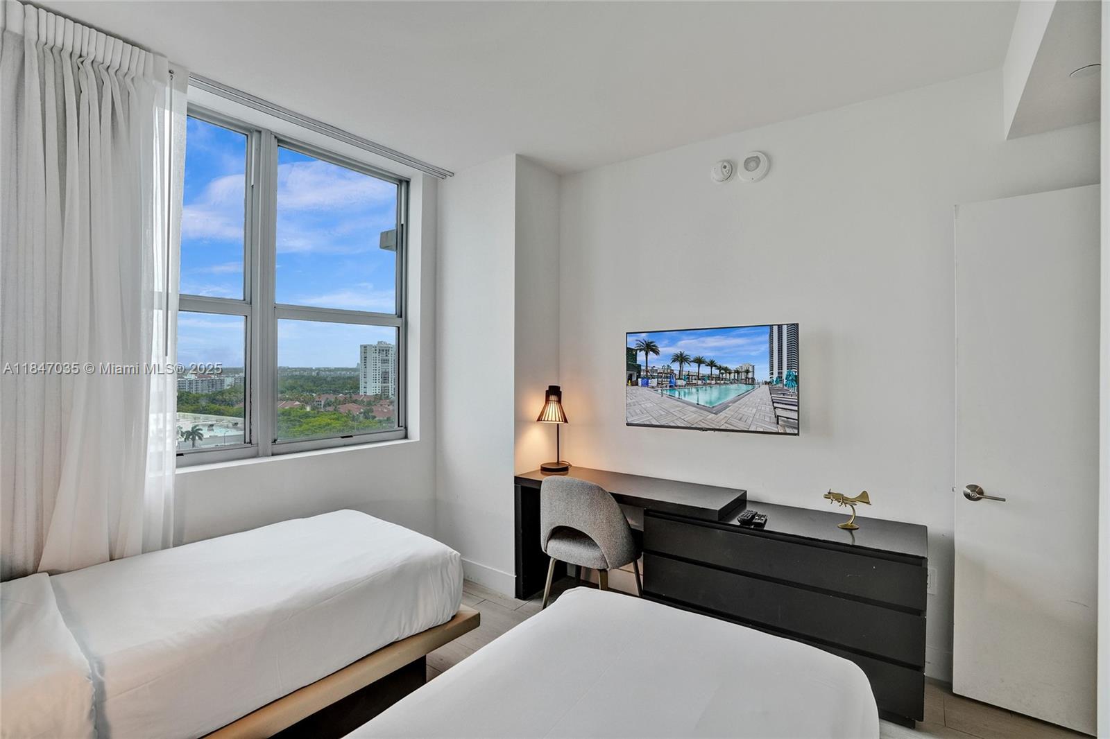 4010 South Ocean Drive, Unit R908 Hollywood, FL 33019 - Photo 39 of 53 a bedroom with a bed and a window