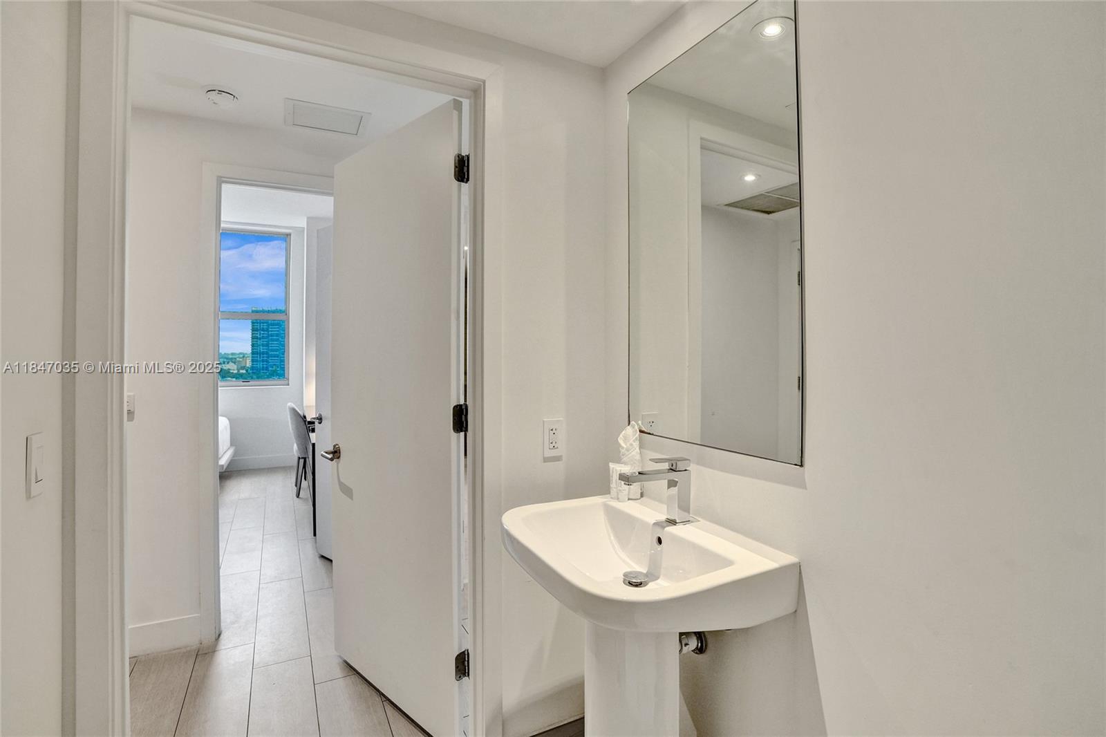4010 South Ocean Drive, Unit R908 Hollywood, FL 33019 - Photo 40 of 53 a bathroom with a sink mirror and shower
