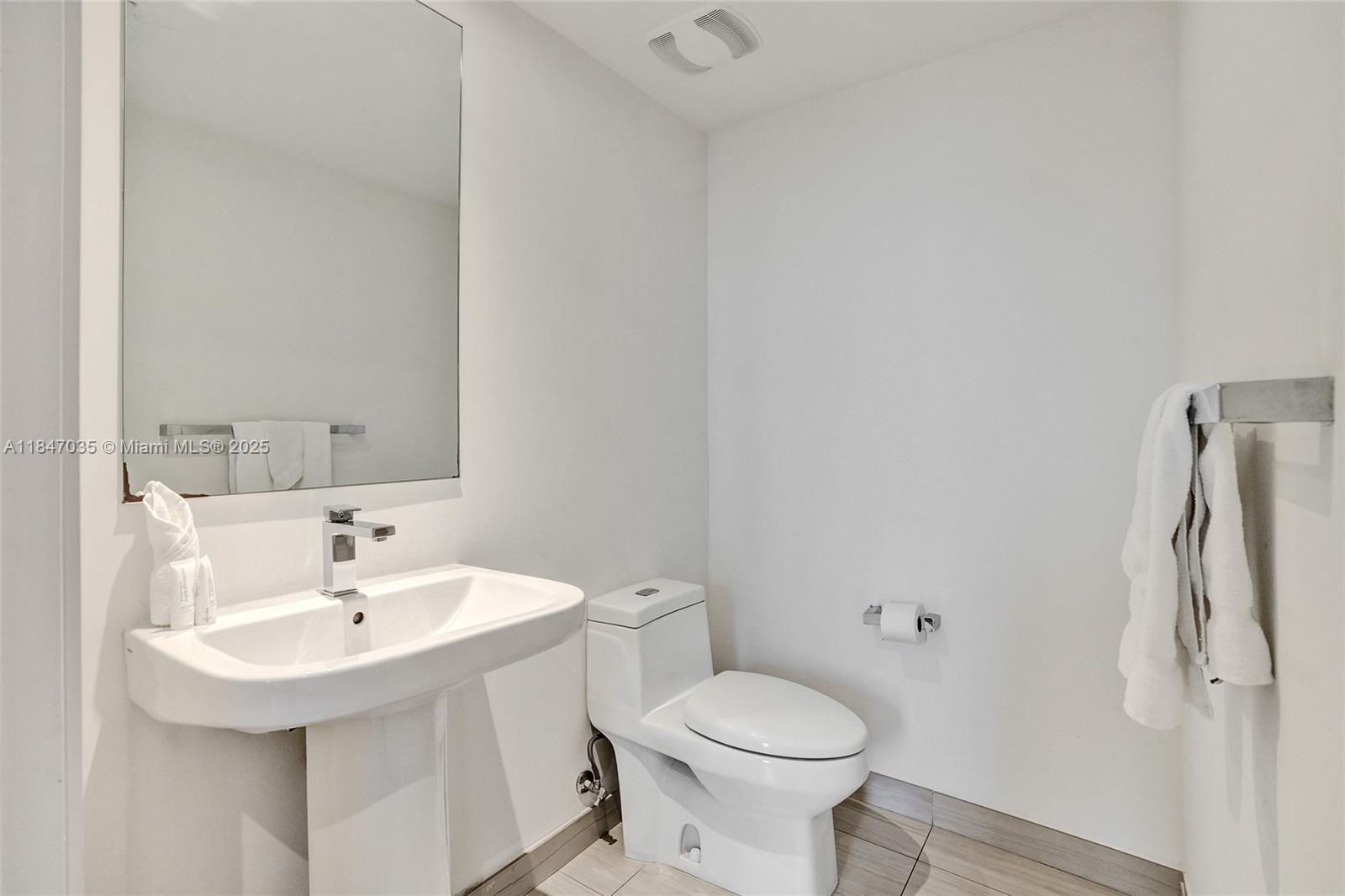 4010 South Ocean Drive, Unit R908 Hollywood, FL 33019 - Photo 41 of 53 a bathroom with a sink toilet and a mirror