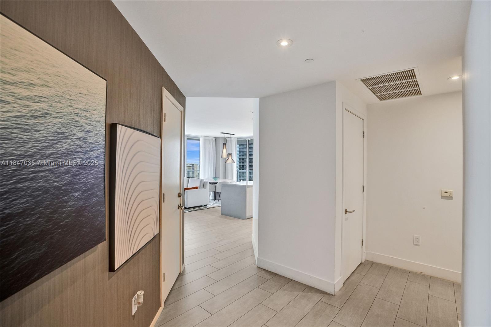4010 South Ocean Drive, Unit R908 Hollywood, FL 33019 - Photo 43 of 53 a view of a refrigerator in kitchen and an empty room