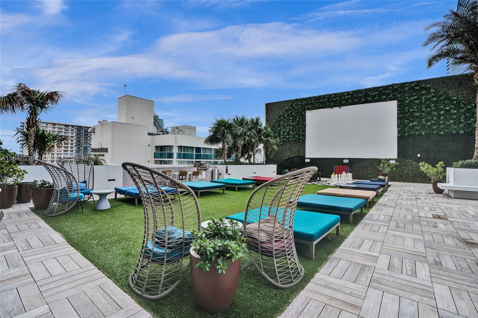 4010 South Ocean Drive, Unit R908 Hollywood, FL 33019 - Photo 46 of 53 a view of a swimming pool with chairs and plants