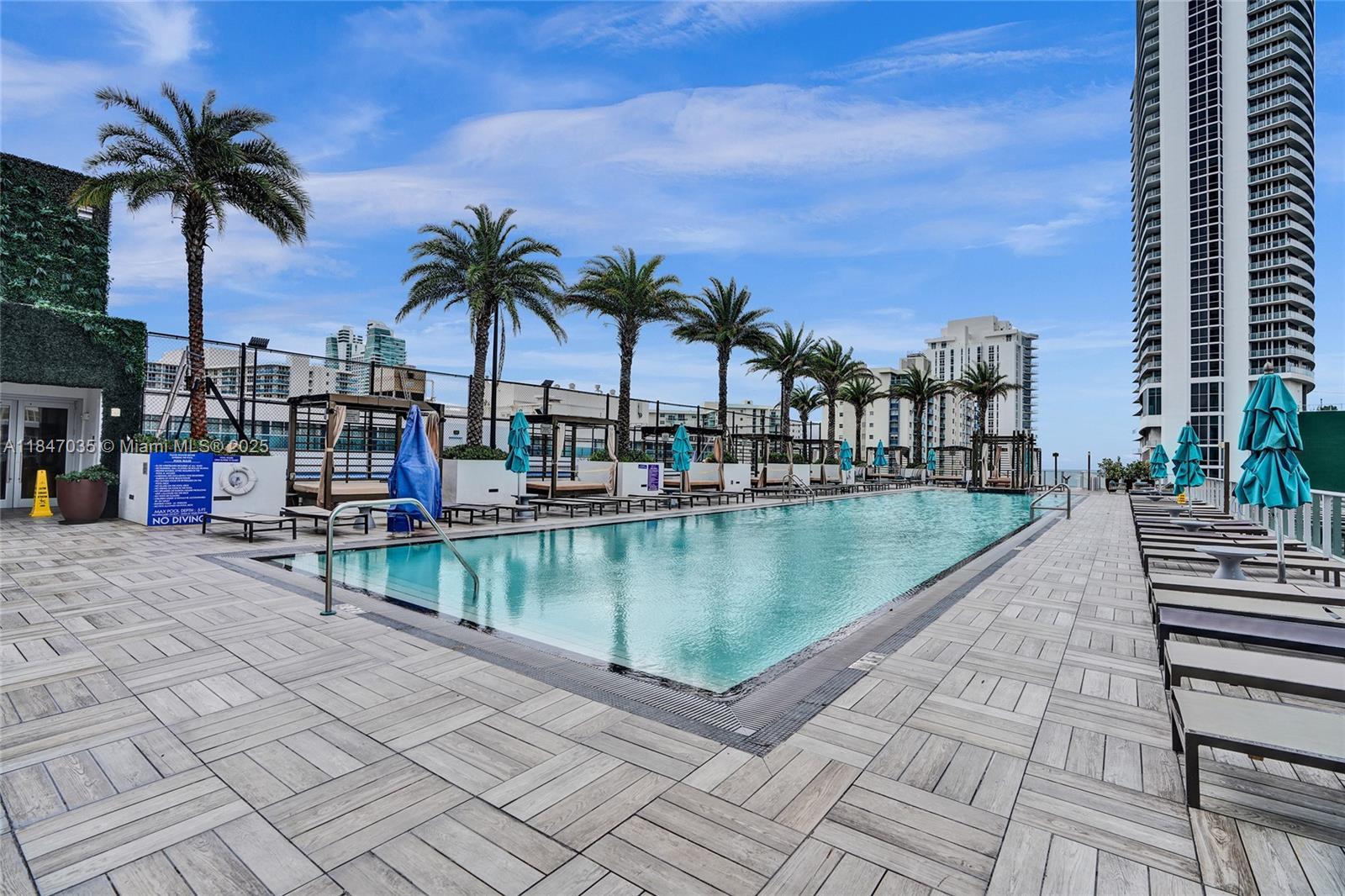 4010 South Ocean Drive, Unit R908 Hollywood, FL 33019 - Photo 49 of 53 a view of swimming pool with outdoor seating and plants