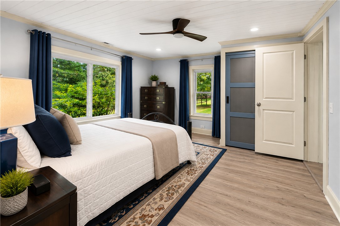 203 Muller Road Walhalla, SC 29691 - Photo 9 of 34 Plank ceilings and classic LVP floors elevate this comfortable garden-view bedroom.
