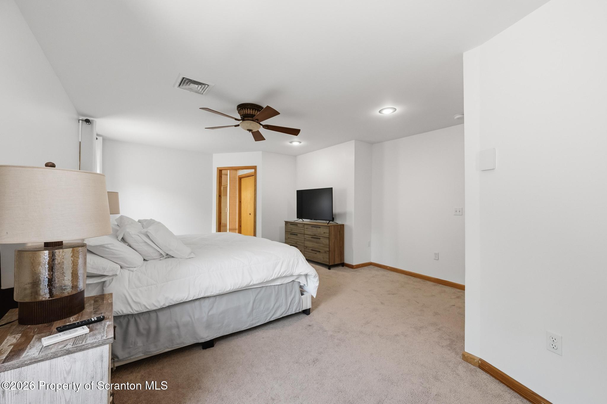 58 Bender Road Gouldsboro, PA 18424 - Photo 20 of 55 a bedroom with a bed and a flat tv screen on dresser