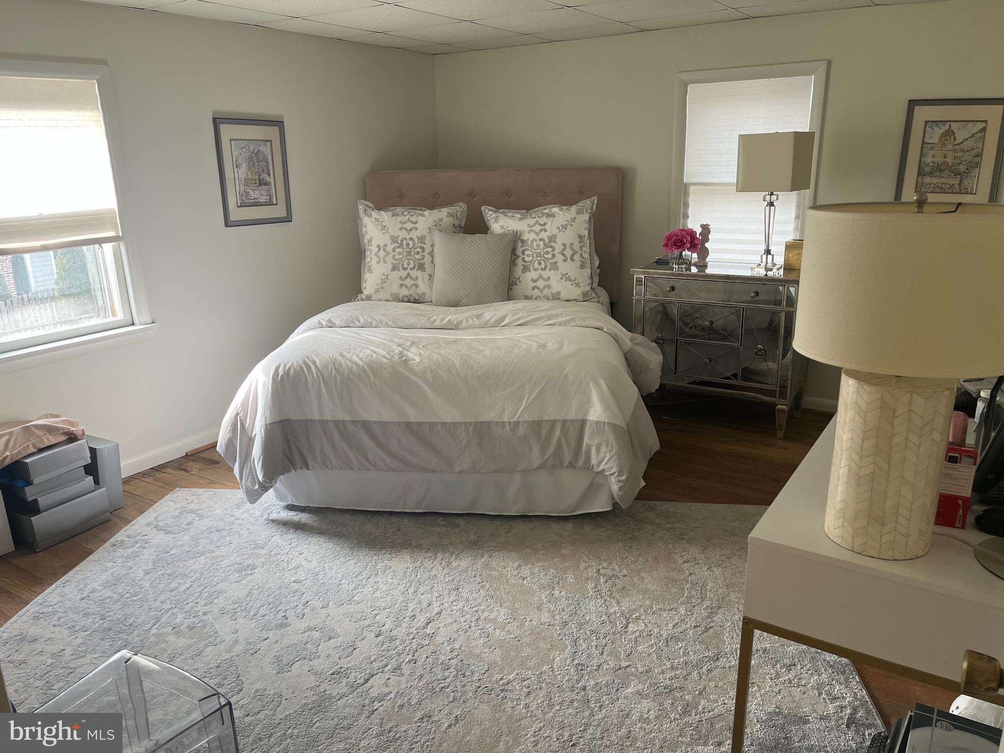 38 South Main Street, Unit 3 Mullica Hill, NJ 08062 - Photo 2 of 10 a bed room with a bed and a chair