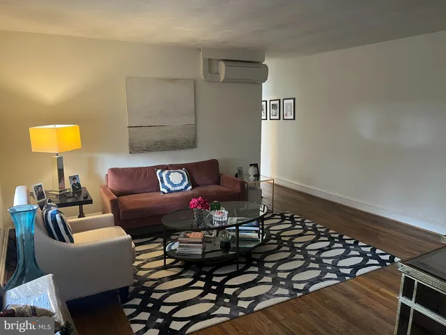 a living room with furniture and a lamp