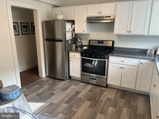 a kitchen with a refrigerator stove and cabinets