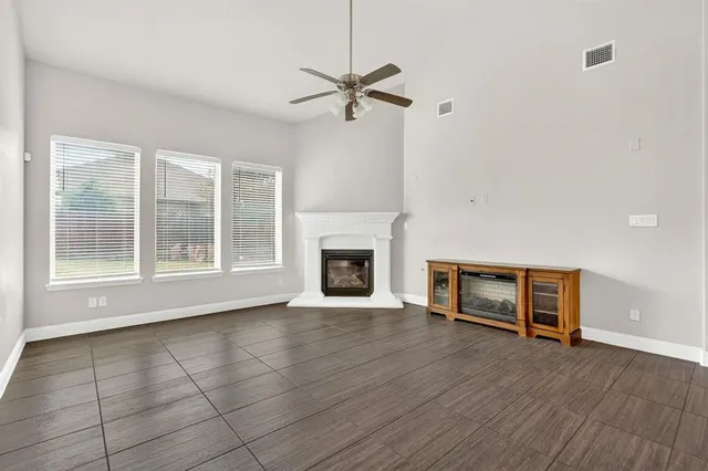 a view of a livingroom with a fireplace and window