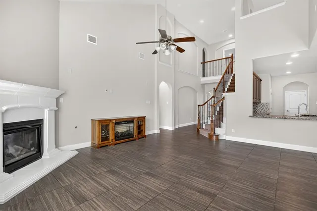 a view of a livingroom with wooden floor and a fireplace