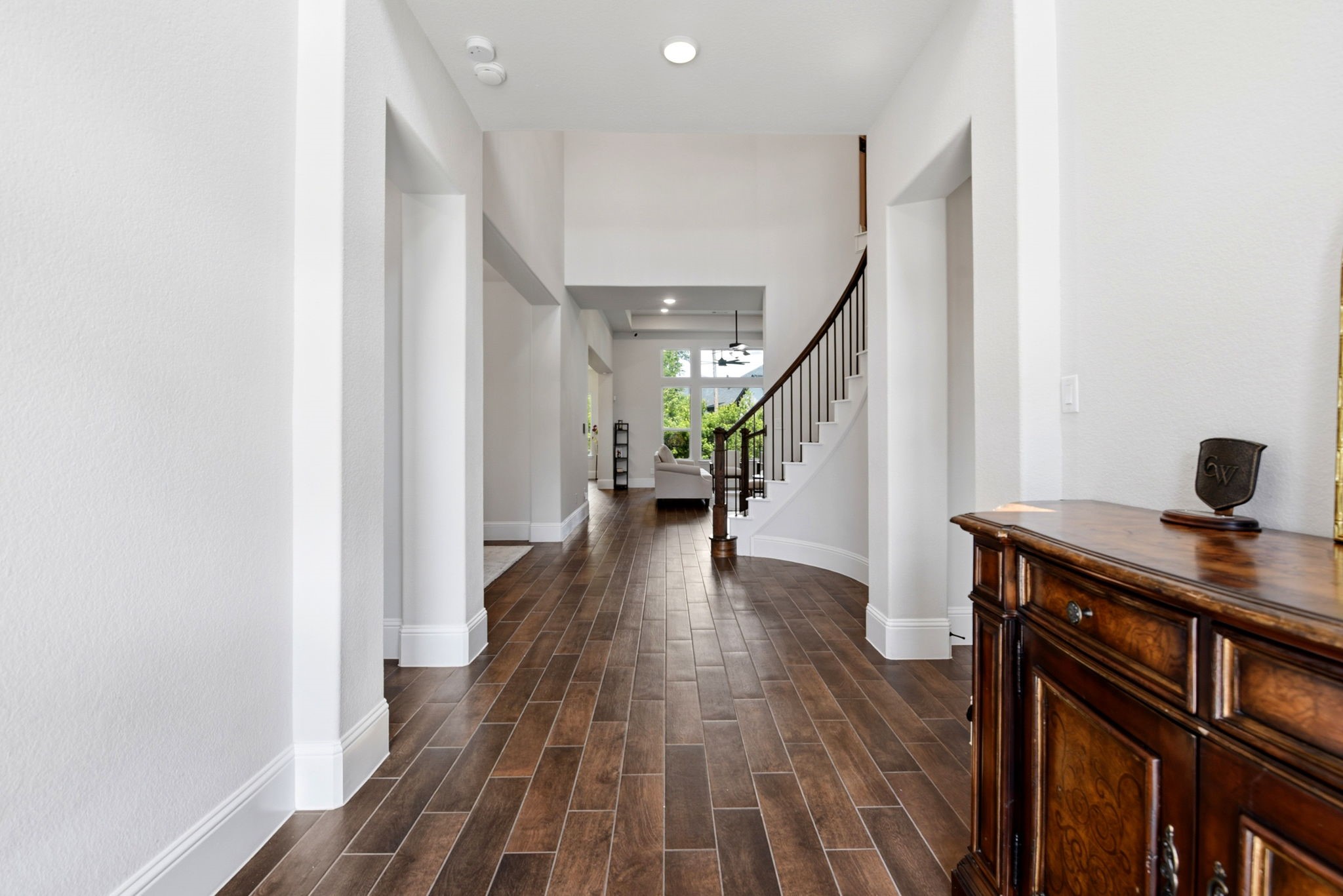 10062 South Goshawk Trail Conroe, TX 77385 - Photo 4 of 43 a view of a hallway with wooden floor and staircase
