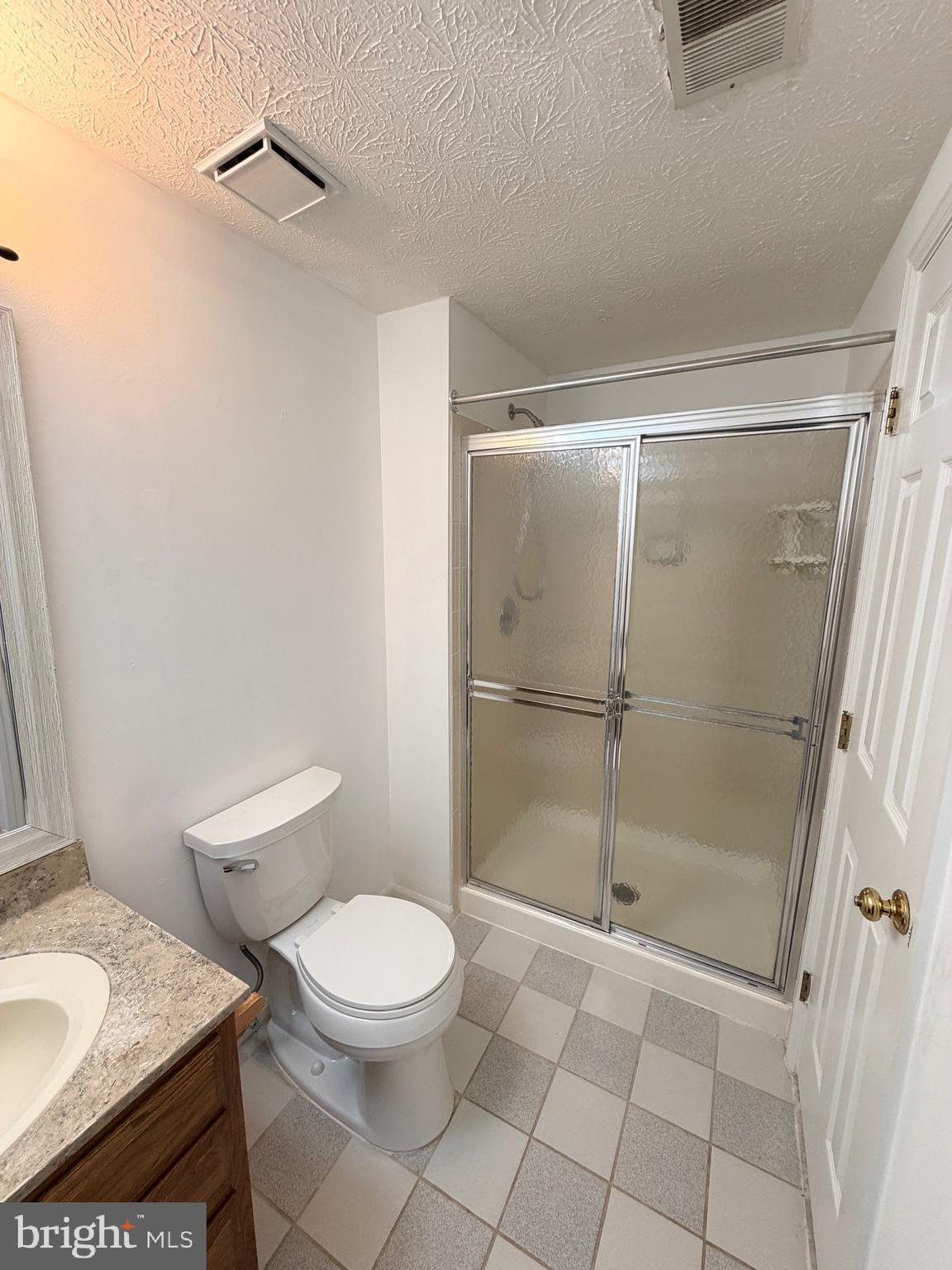 13953 Winding Ridge Lane Centreville, VA 20121 - Photo 17 of 23 a bathroom with a granite countertop toilet a sink and a shower