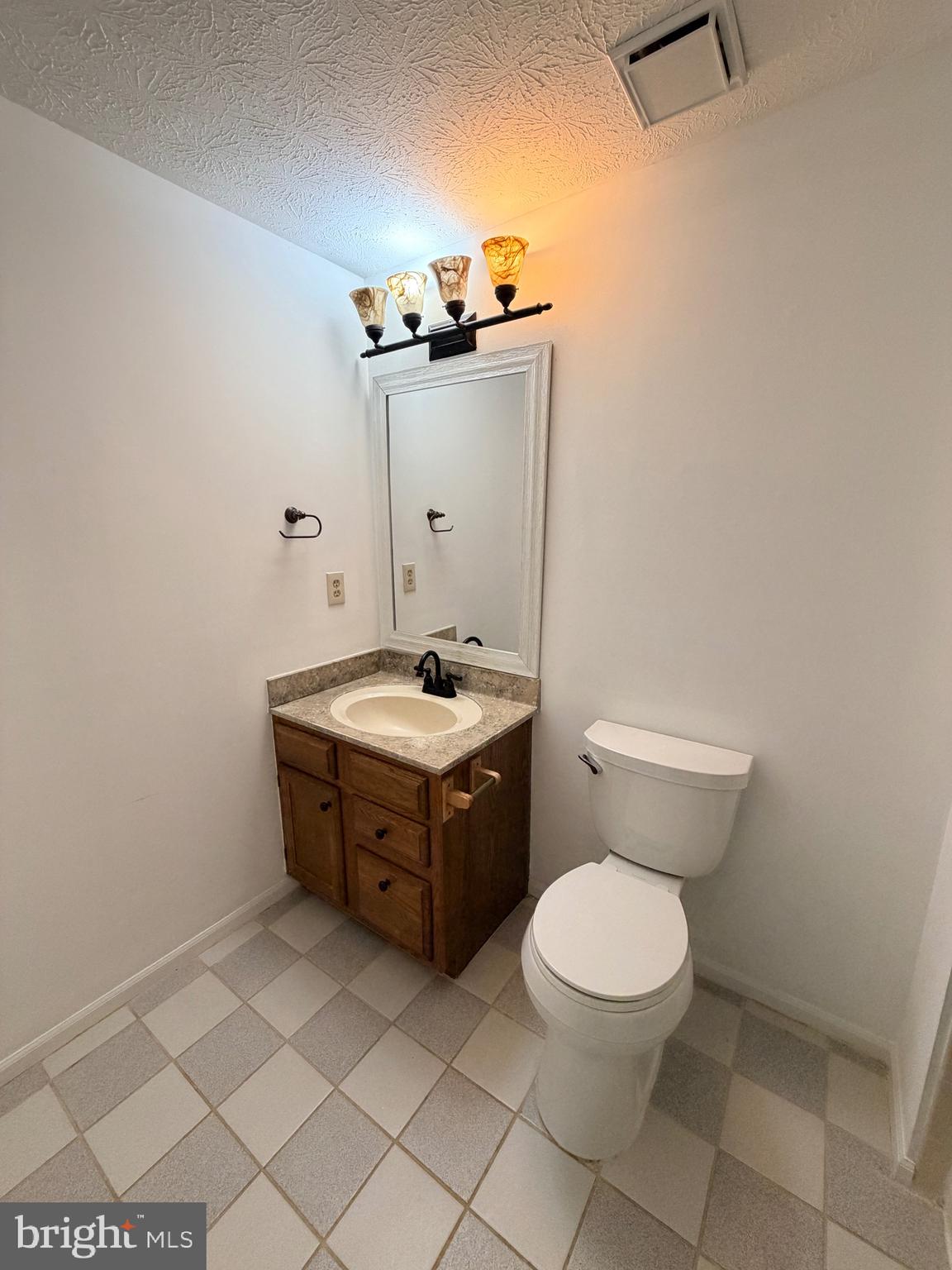 13953 Winding Ridge Lane Centreville, VA 20121 - Photo 18 of 23 a bathroom with a toilet sink and mirror